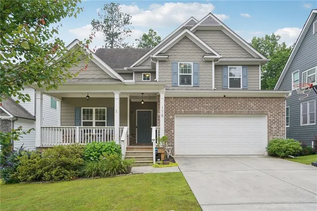 a front view of a house with a garden