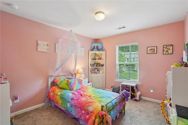 a bedroom with two beds and a window