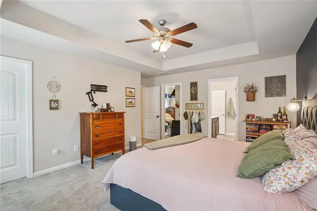 a bed room with a bed and a ceiling fan