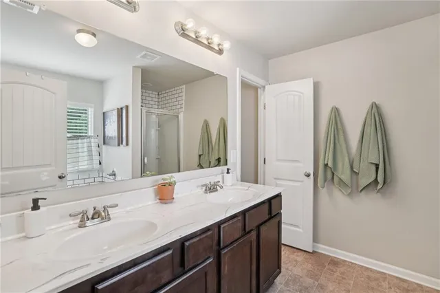 a bathroom with a double vanity sink and a mirror