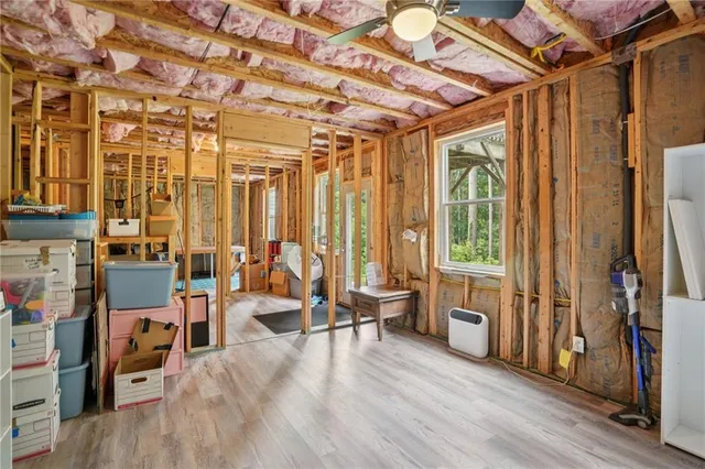 a view of a room with lots of furniture and windows