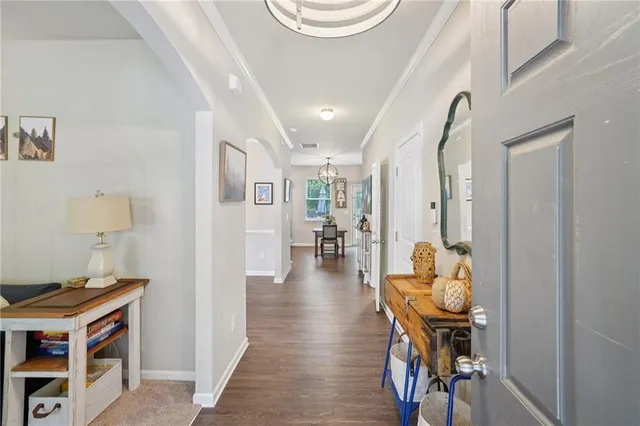 a very nice looking room with wooden floor and furniture