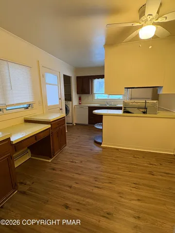 a kitchen with stainless steel appliances granite countertop a sink and a stove