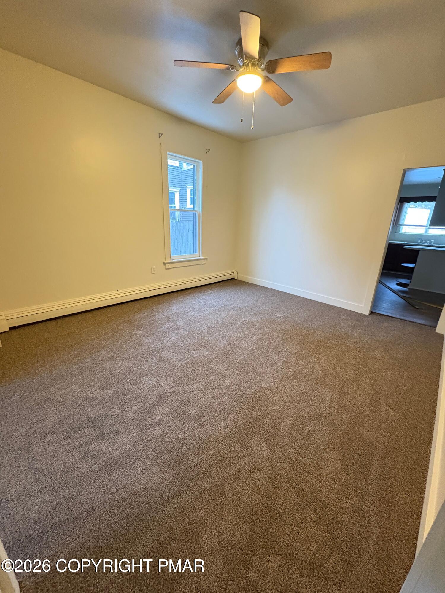 622 Scott Street Stroudsburg, PA 18360 - Photo 6 of 14 an empty room with windows and chandelier fan