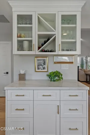 a kitchen with a white cabinets and a stove