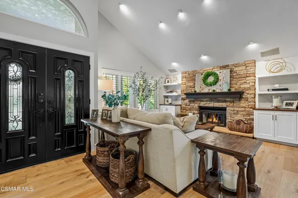 a living room with furniture a fireplace and a table