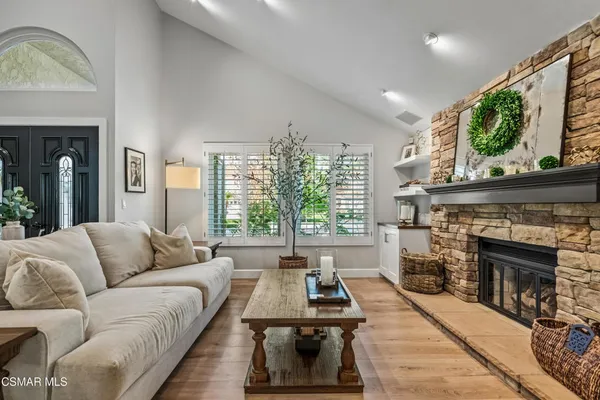 a living room with furniture a window and a fireplace
