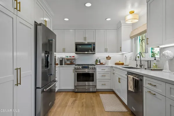 a kitchen with cabinets and stainless steel appliances