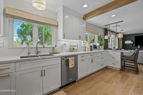 a kitchen with sink cabinets and wooden floor