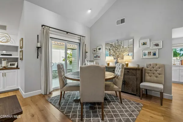 a dining room with furniture a rug and wooden floor