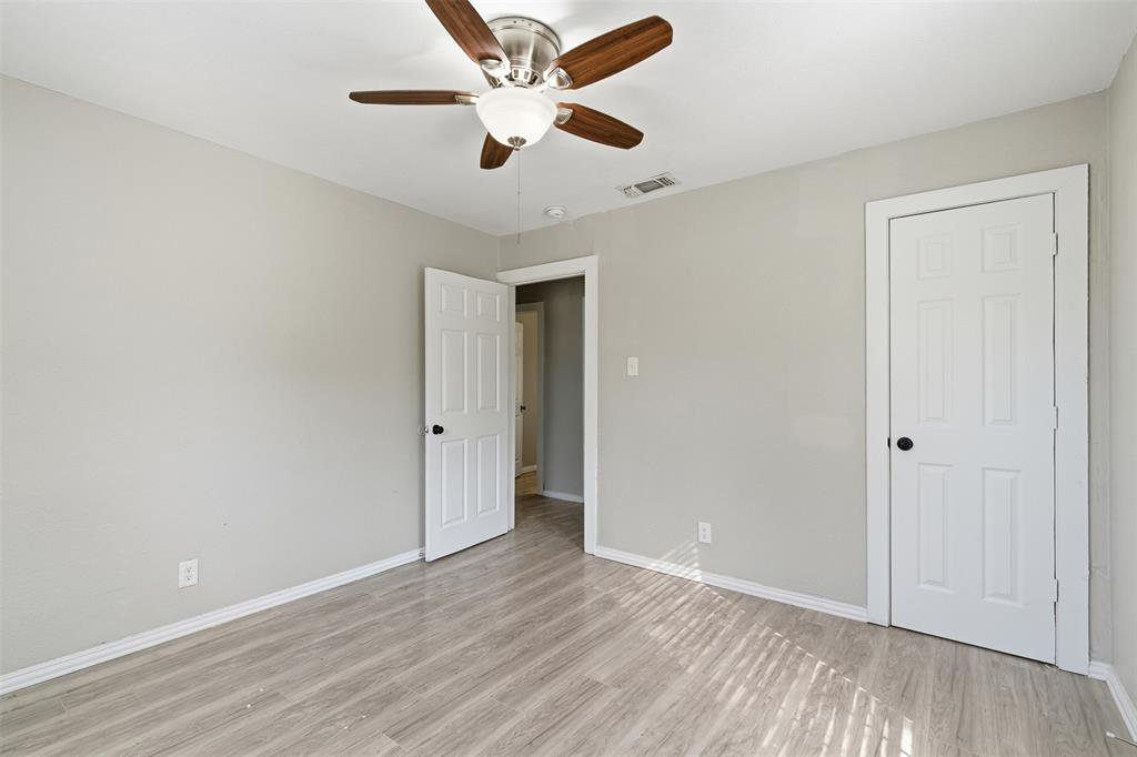 405 North Carr Avenue Sherman, TX 75090 - Photo 17 of 22 an empty room with wooden floor and a ceiling fan