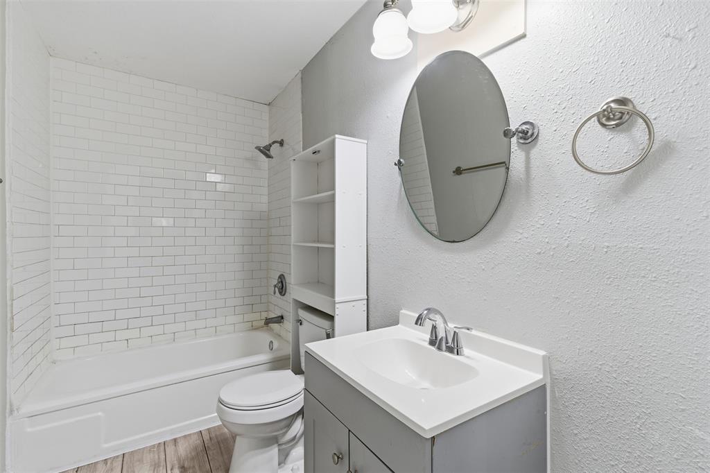 405 North Carr Avenue Sherman, TX 75090 - Photo 19 of 22 a bathroom with a toilet sink and mirror