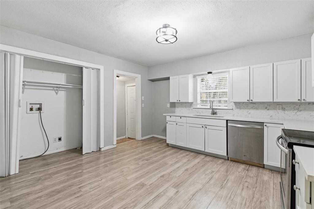 405 North Carr Avenue Sherman, TX 75090 - Photo 4 of 22 a kitchen with a refrigerator a sink and cabinets