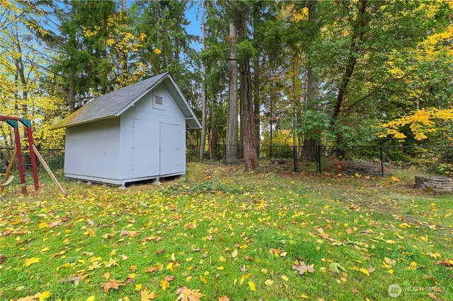 a backyard of a house with table and chairs