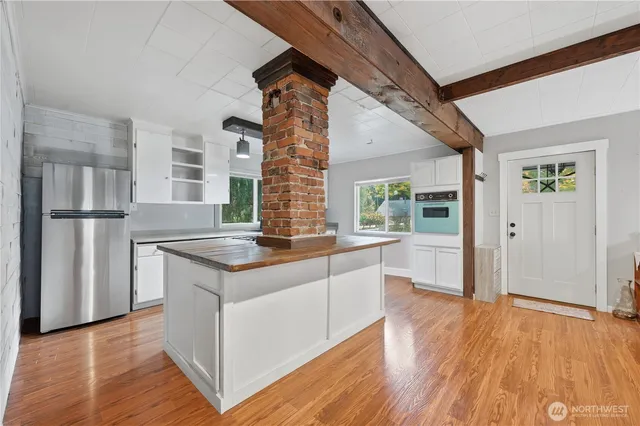 a kitchen with stainless steel appliances granite countertop a stove and a refrigerator