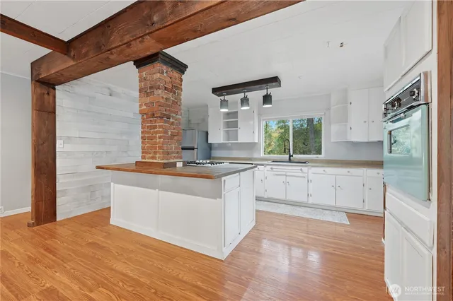 a kitchen with stainless steel appliances granite countertop a sink and a stove