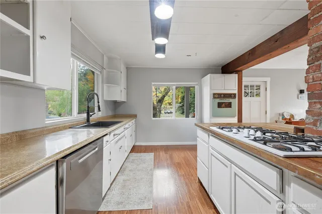 a kitchen with stainless steel appliances granite countertop a stove and a sink