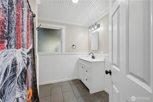 a bathroom with a double vanity sink mirror and bathtub