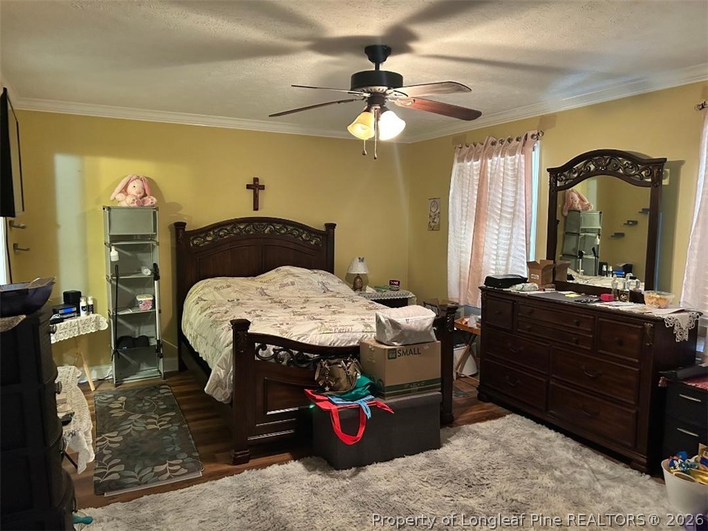 3085 Westminster Road Lumberton, NC 28360 - Photo 13 of 19 a bedroom with a bed and a chandelier