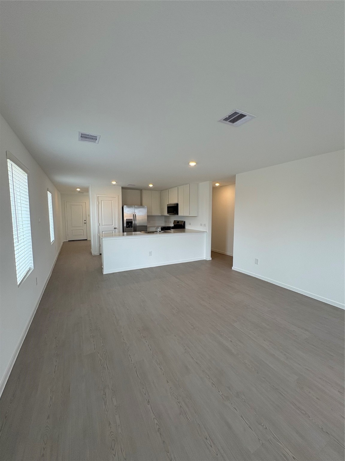 5727 Little Redwing Drive Baytown, TX 77521 - Photo 5 of 25 a view of a kitchen with a sink and dishwasher a stove top oven with wooden floor