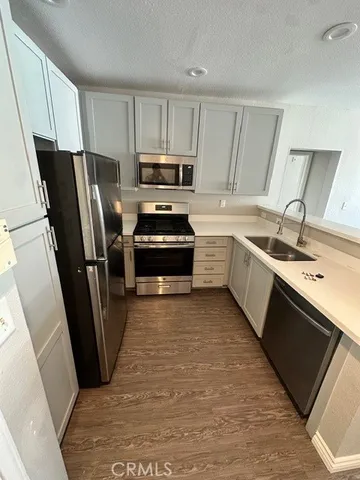 a kitchen with stainless steel appliances granite countertop a refrigerator stove a sink and dishwasher