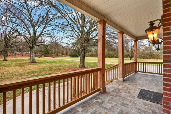 a view of a porch with a floor to ceiling window and a yard