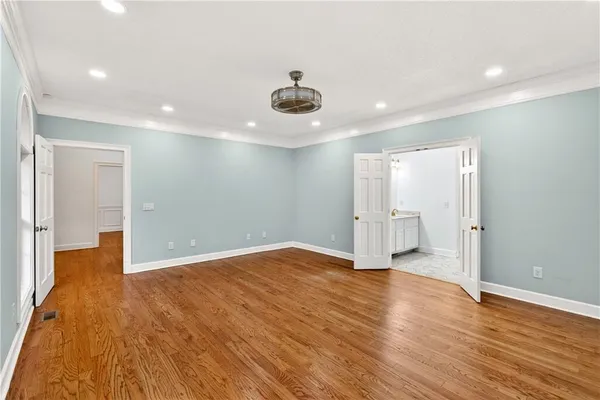 a view of empty room with wooden floor