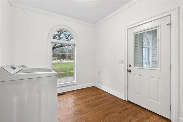 a view of a room with a window and a ceiling fan