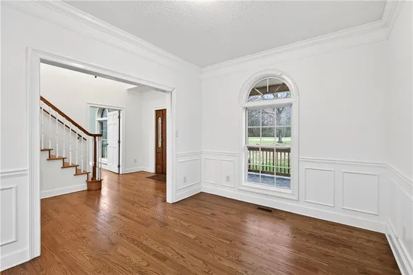 a view of a dining room with furniture and wooden floor