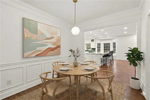 a open kitchen with white cabinets and stainless steel appliances