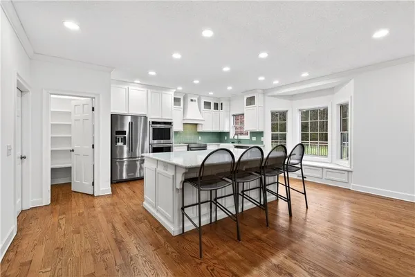 a kitchen with granite countertop a stove top oven and cabinets