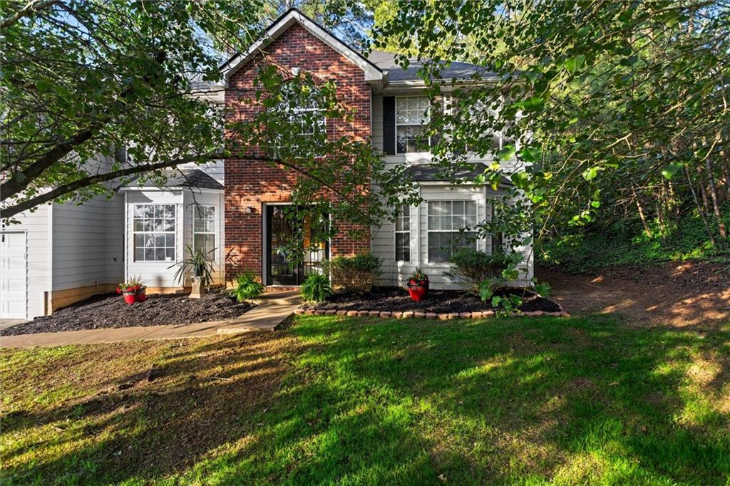 3234 Mineral Ridge Lane Stone Mountain, GA 30087 - Photo 54 of 55 a front view of a house with a yard