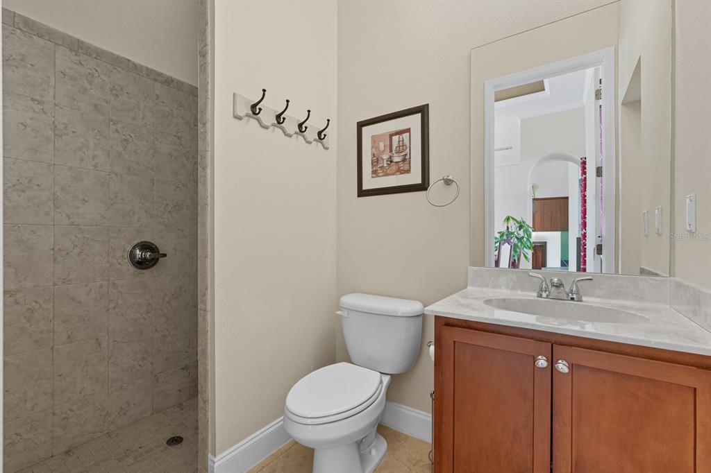 430 Lambert Avenue Flagler Beach, FL 32136 - Photo 16 of 63 a bathroom with a granite countertop toilet a sink and mirror