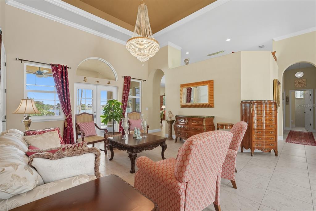 430 Lambert Avenue Flagler Beach, FL 32136 - Photo 17 of 63 a living room with furniture a large window and a chandelier