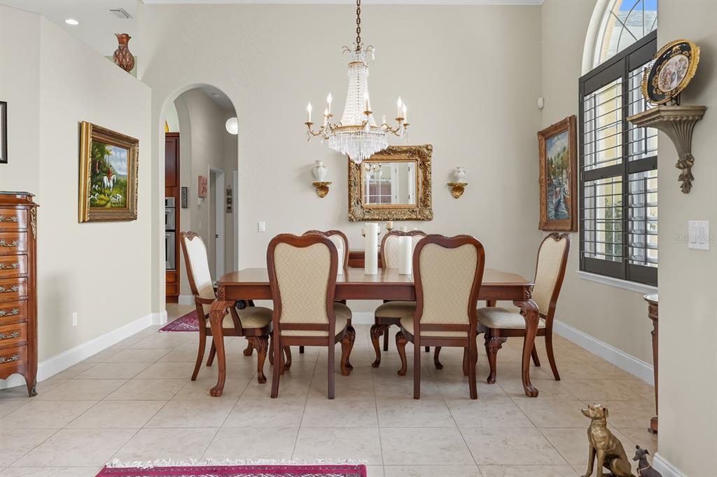 430 Lambert Avenue Flagler Beach, FL 32136 - Photo 20 of 63 a view of a dining room with furniture and chandelier