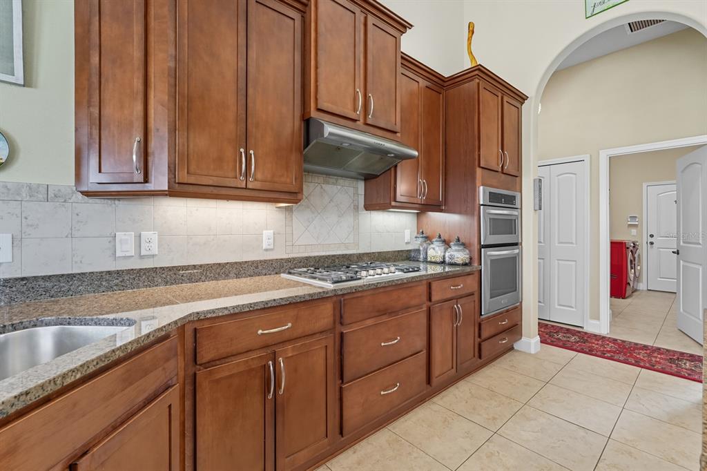 430 Lambert Avenue Flagler Beach, FL 32136 - Photo 24 of 63 a kitchen with stainless steel appliances granite countertop a stove and a sink