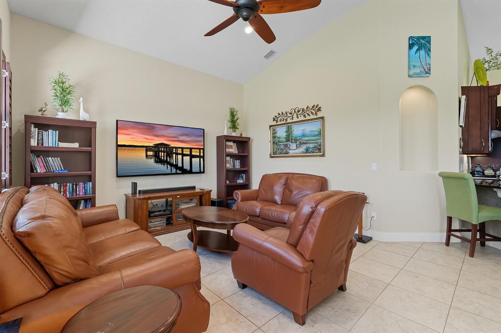 430 Lambert Avenue Flagler Beach, FL 32136 - Photo 27 of 63 a living room with furniture and a flat screen tv