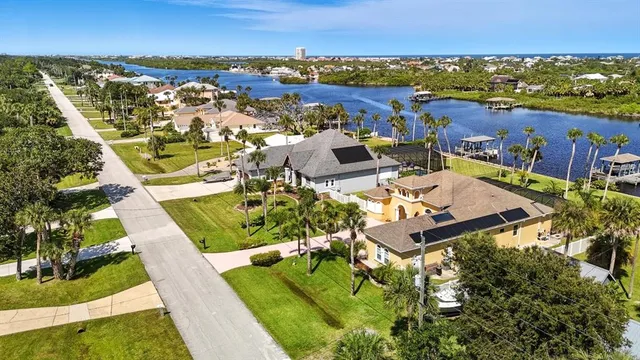 an aerial view of a house with a ocean view