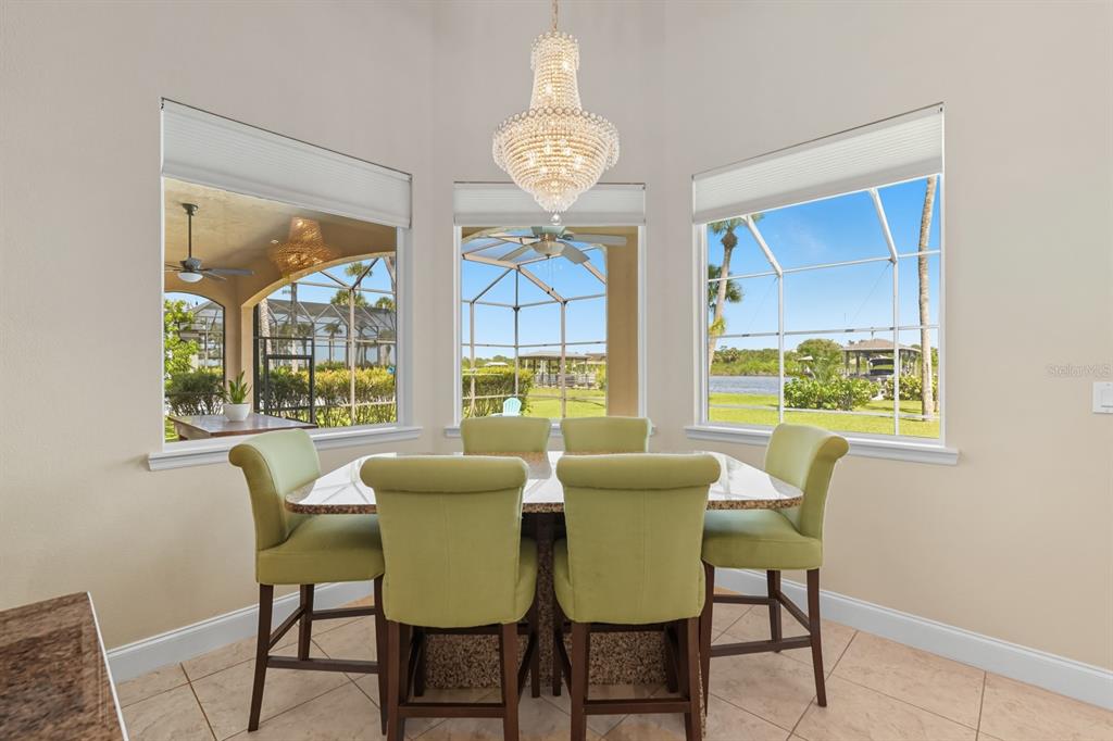 430 Lambert Avenue Flagler Beach, FL 32136 - Photo 31 of 63 a view of a dining room with furniture a chandelier and a window