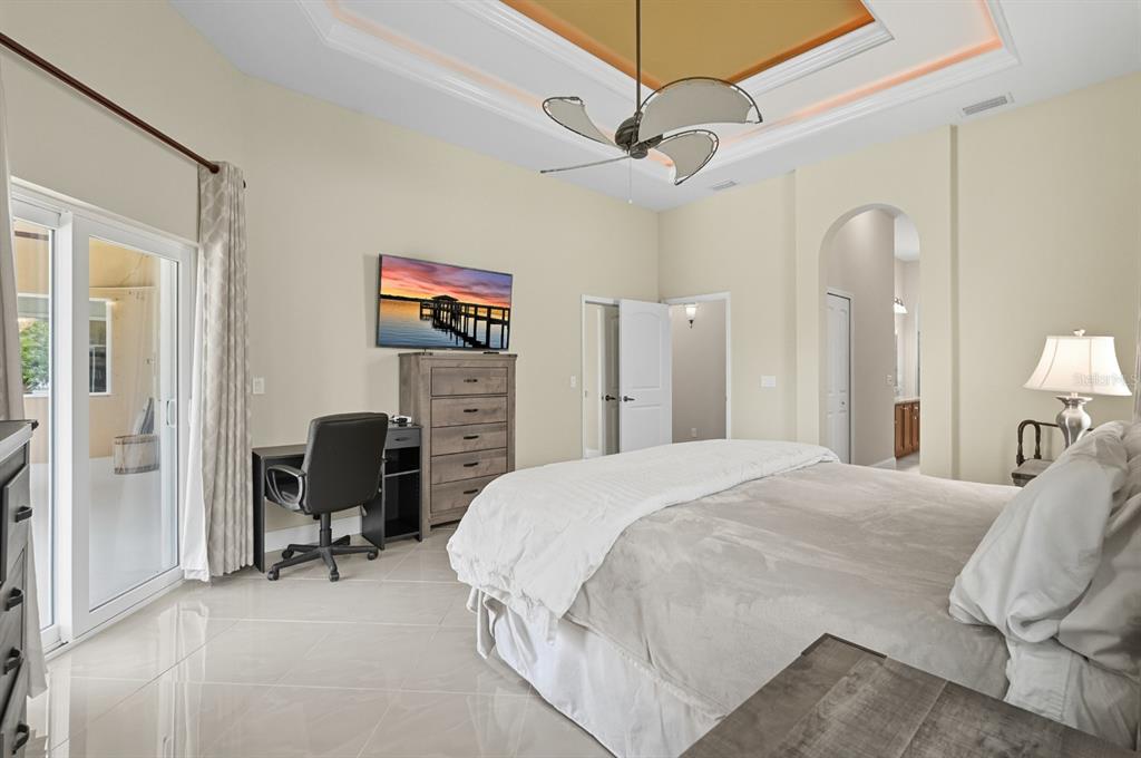 430 Lambert Avenue Flagler Beach, FL 32136 - Photo 34 of 63 a spacious bedroom with a bed a desk and chair