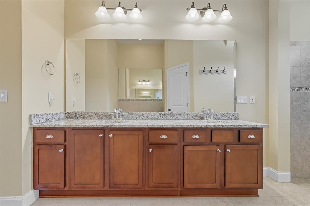 430 Lambert Avenue Flagler Beach, FL 32136 - Photo 38 of 63 a bathroom with a granite countertop sink and a mirror