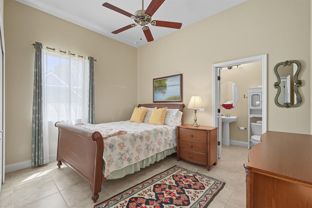 430 Lambert Avenue Flagler Beach, FL 32136 - Photo 40 of 63 a bedroom with a bed and a chandelier