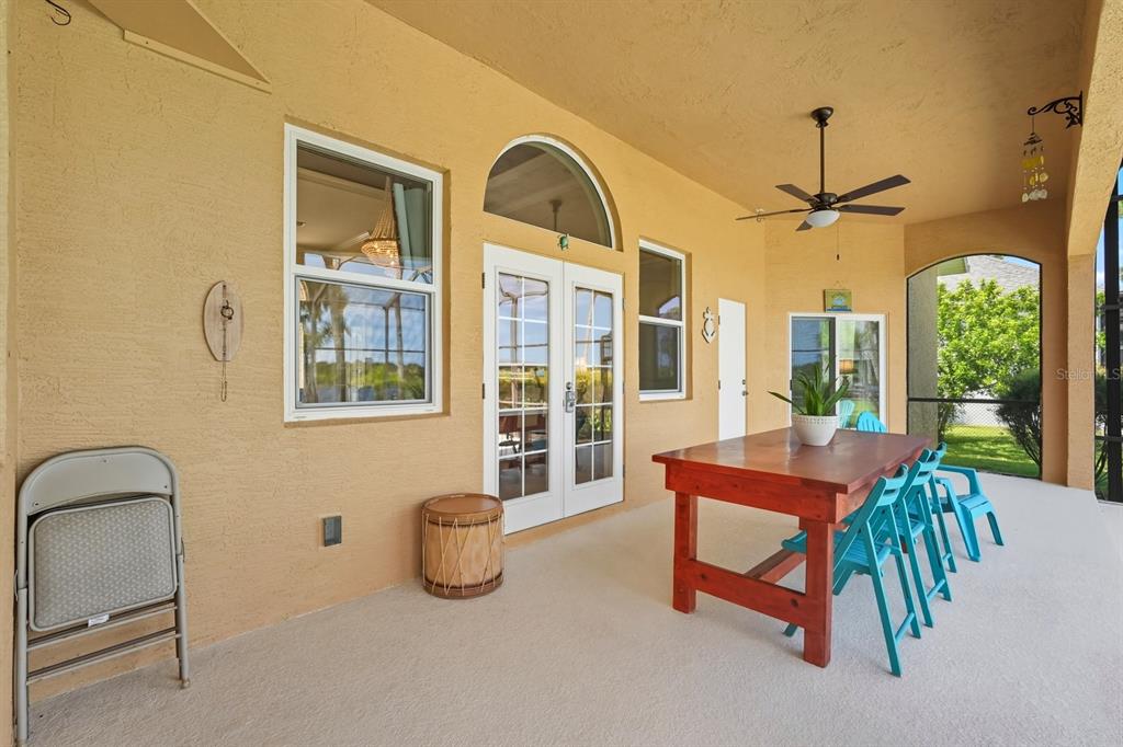 430 Lambert Avenue Flagler Beach, FL 32136 - Photo 44 of 63 a dining room with furniture a chandelier and a rug