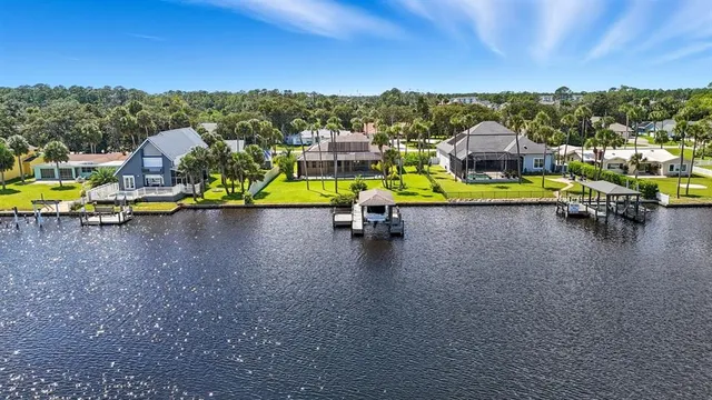 an aerial view of a swimming pool with outdoor seating