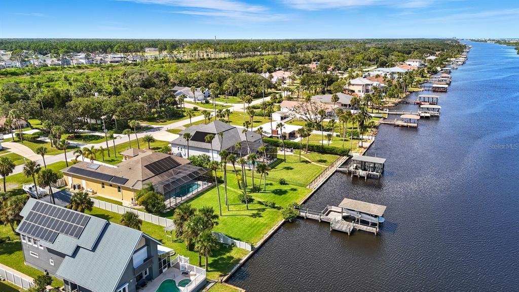 430 Lambert Avenue Flagler Beach, FL 32136 - Photo 7 of 63 an aerial view of a house with a garden and lake view