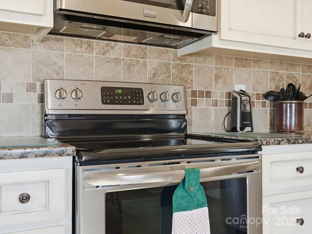 a stove top oven sitting inside of a kitchen