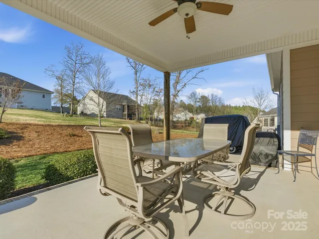 a view of a porch with furniture and garden