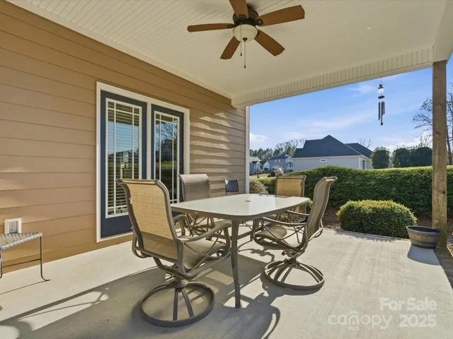 a dining room with furniture and a floor to ceiling window
