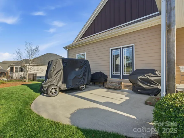a view of a house with a patio and a yard