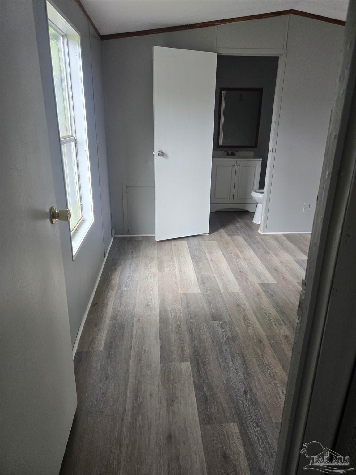 5675 Saufley Field Road, Unit 9 Pensacola, FL 32526 - Photo 15 of 15 wooden floor in an empty room with a window